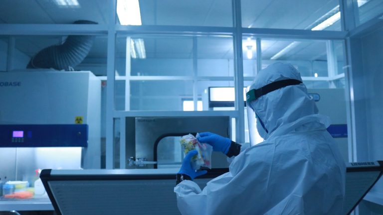 a laboratory worker is using a pcr swab in a hospital